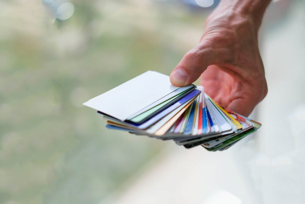 A man is holding a stack of discount cards.