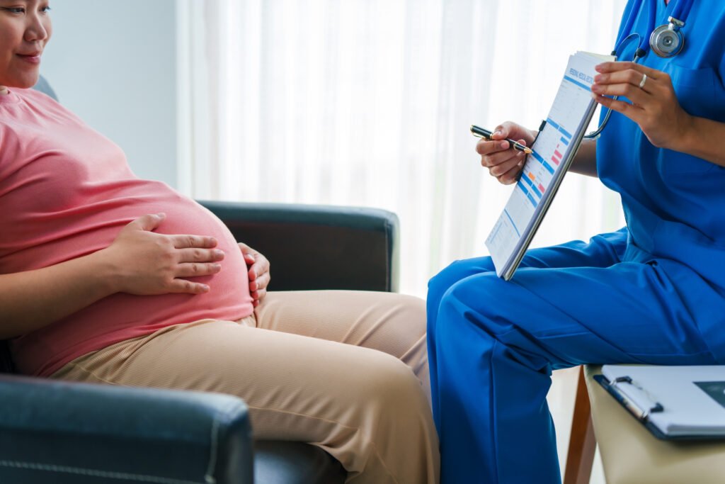 Asian female doctor and nurse use ultrasound and stethoscope on a pregnant woman, healthy birth.