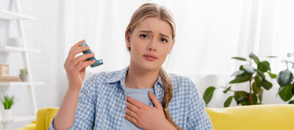 Asthma woman holding inhaler at home, banner