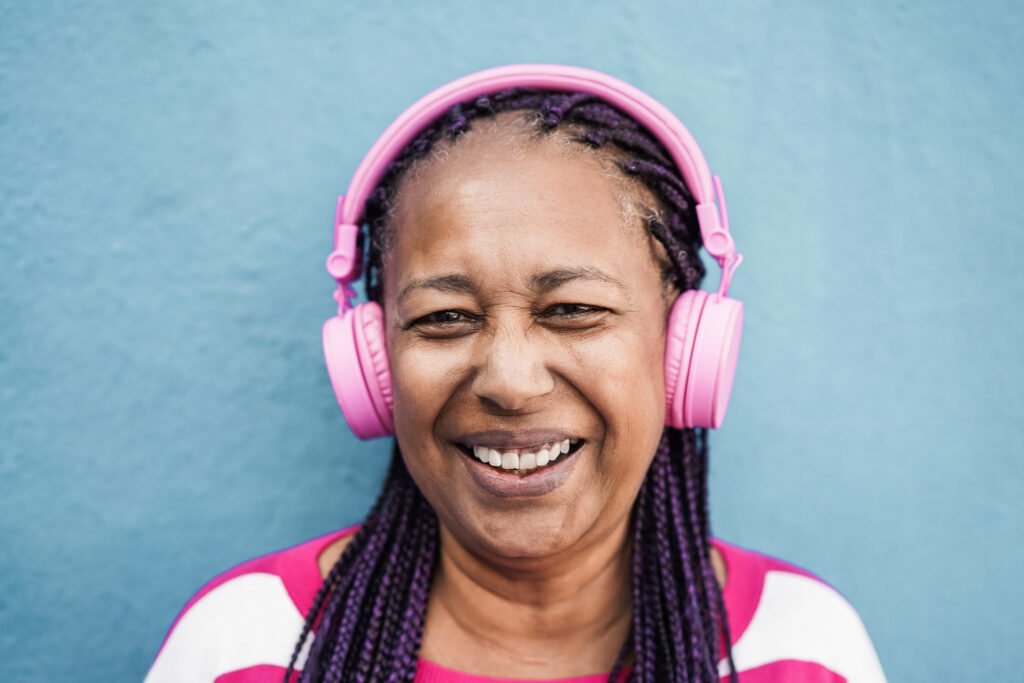 Senior african girl listen playlist music with headphones.