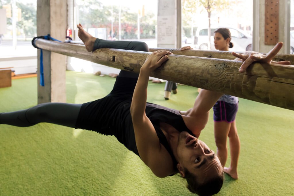 student and trainer do functional training together in environmental friendly gym.