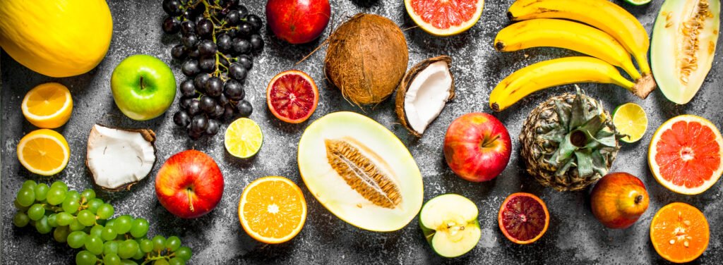 variety of fresh fruits for diabetics on rustic background .