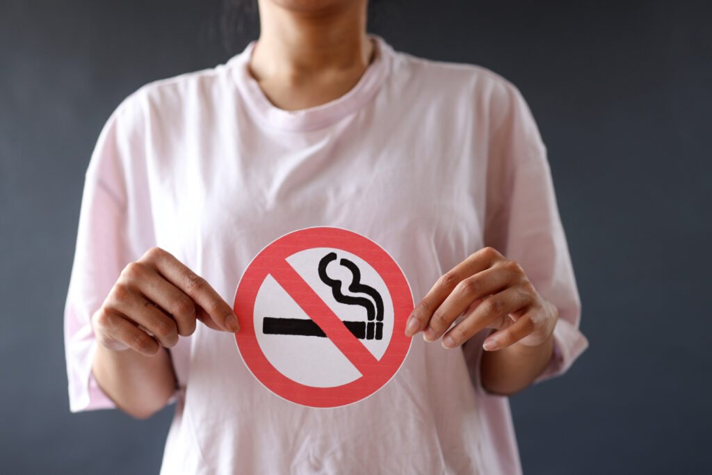 woman-holding-no-smoking-sign