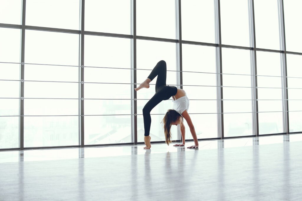 girl wearing white and black sports dress showing Flexibility.