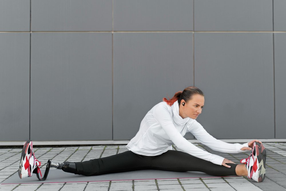 women in white and black sports wear performing  streching to be physically fit.