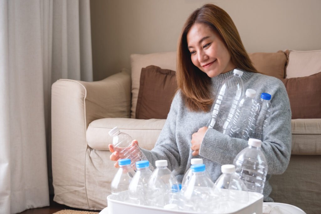 Portrait image of a woman collecting water bottels to shoe the cure of dehydration.