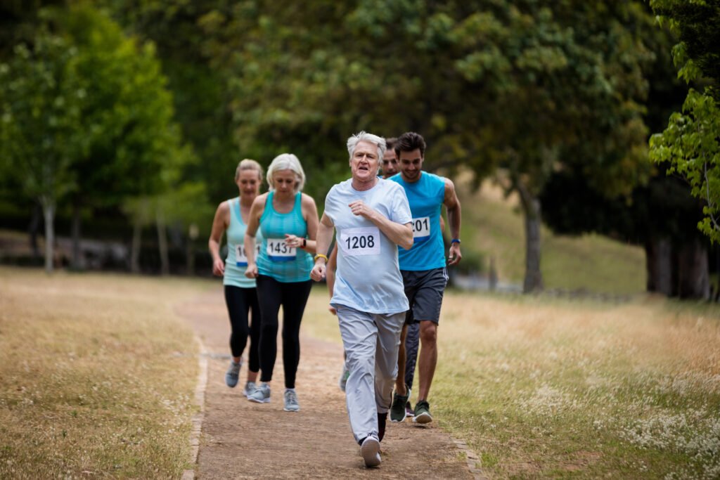 Athletes running race in park on sunny a day