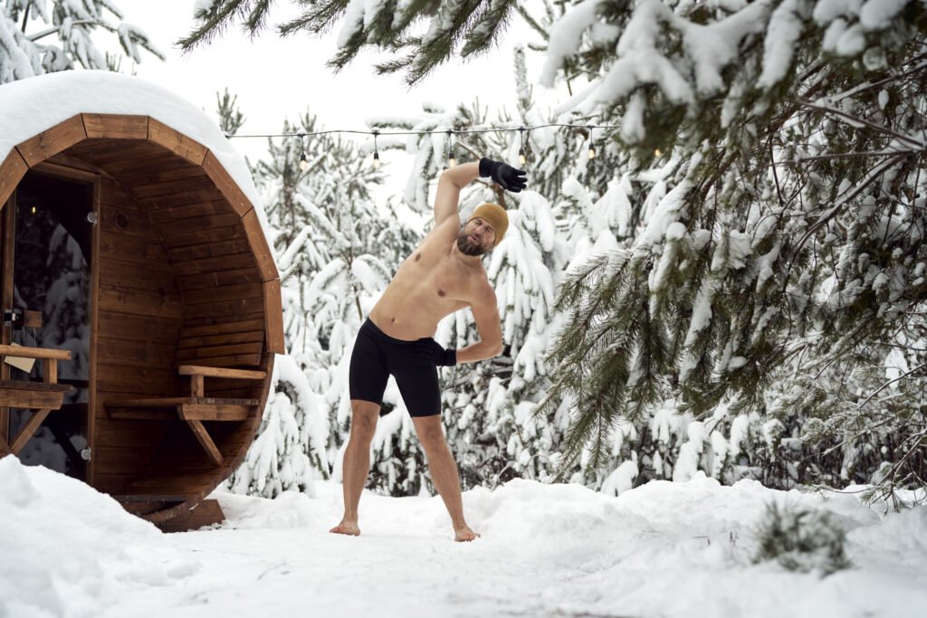 Caucasian man warming up before winter swim in barrel