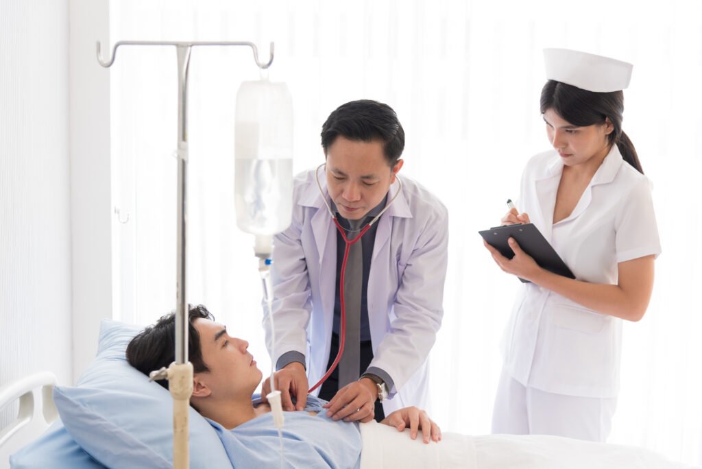 Doctor and nurse in working uniform taking care and diagnosis symptoms on the bed.