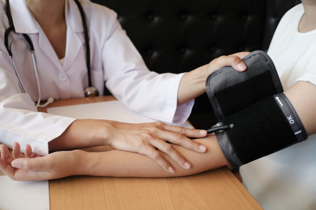 Doctor checking  patient arterial blood pressure. caused by dehydration Health care.