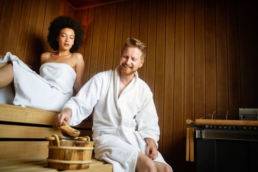 Happy couple having a steam bath in a sauna and relax