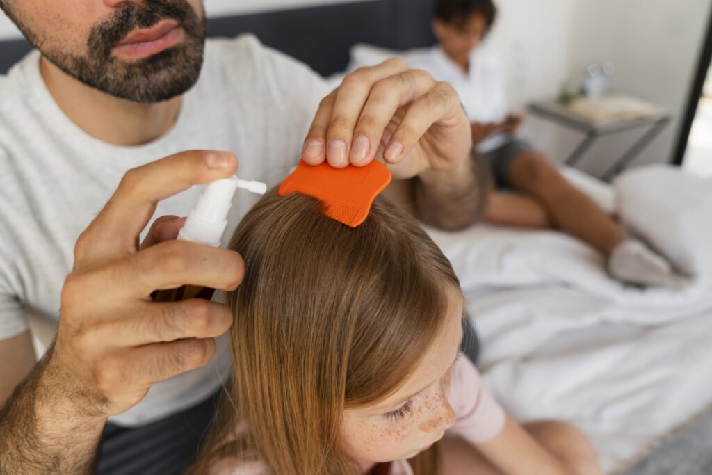 high-angle-father-using-lice-treatment-comb