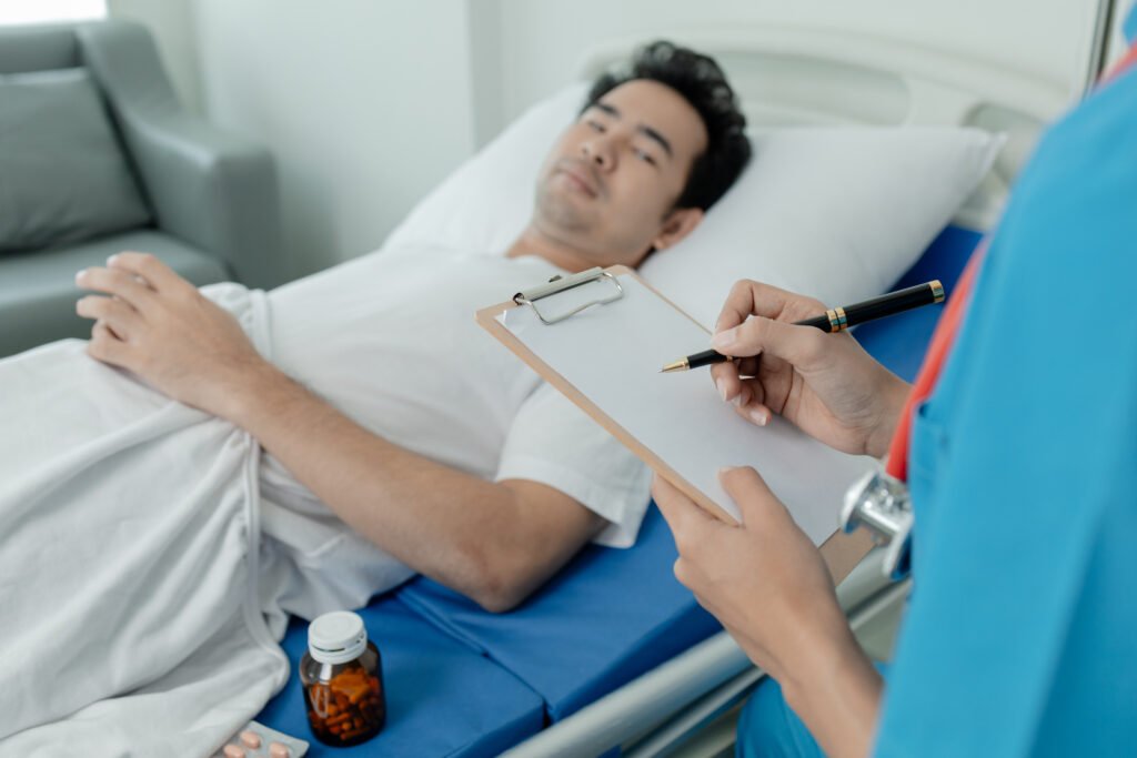 Patient on an inpatient hospital bed with a doctor examining and asking for information about the symptoms in order to diagnose the correct and appropriate treatment.