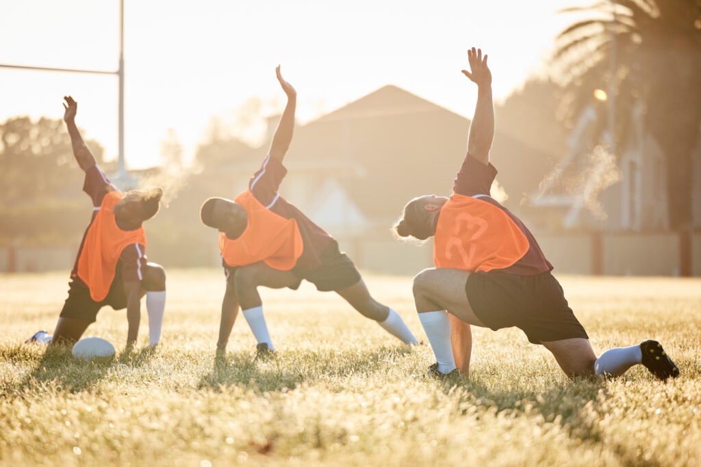 Rugby, club and team stretching at training for match or competition in the morning doing warm up e.