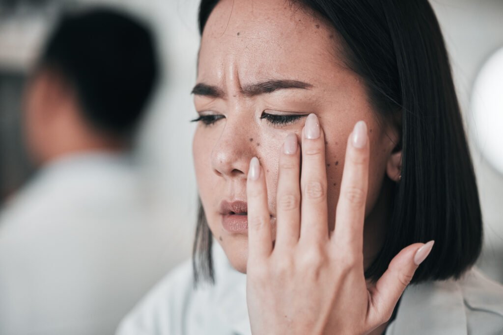 Stress, headache and scientist woman in laboratory working with microscope, tech and pharmaceutical.