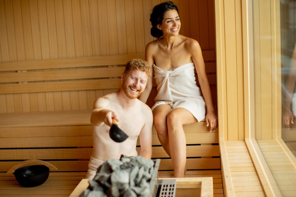 Handsome young couple relaxing in the sauna